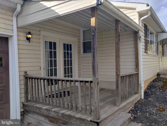 a view of a house with wooden deck