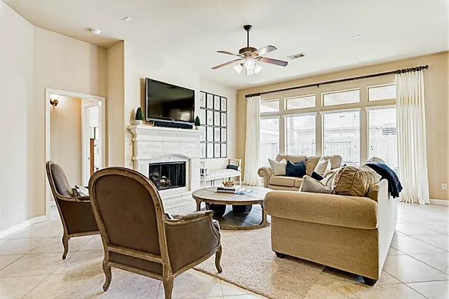 a living room with furniture a flat screen tv and a fireplace