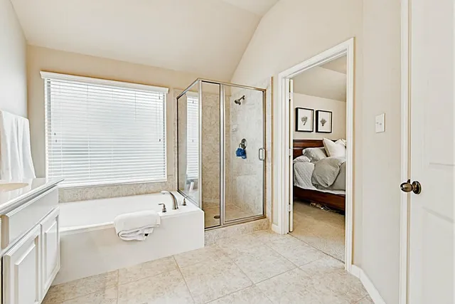 a bathroom with a double vanity sink mirror and bathtub