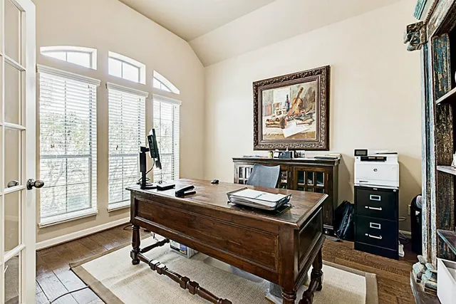 a living room with furniture a flat screen tv and a book shelf