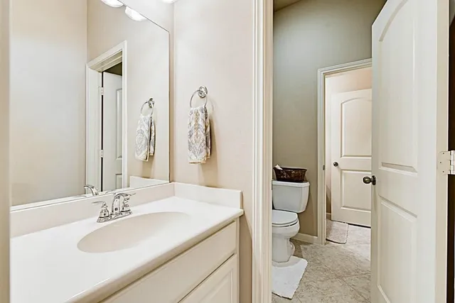 a living room with furniture a rug and a bookshelf