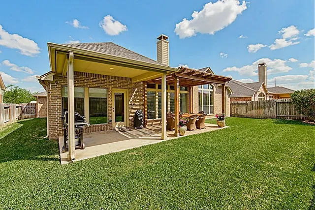 a view of a patio with a table chairs and backyard