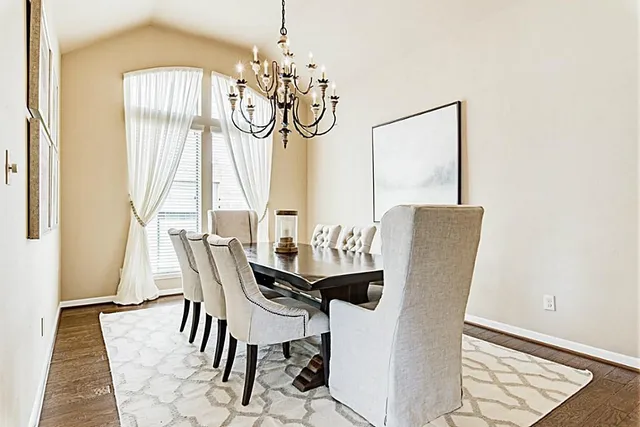 a view of a dining room with furniture and chandelier