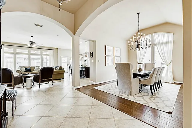 a kitchen with furniture wooden floor and stainless steel appliances