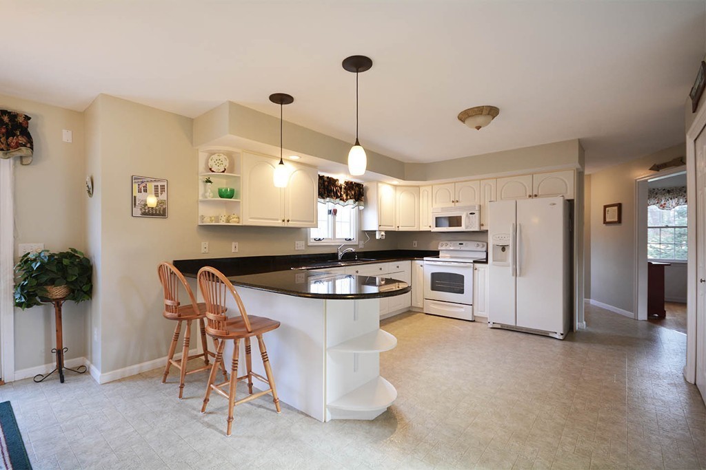 5 Ridge Road Pepperell, MA 01463 - Photo 3 of 25 a kitchen with refrigerator and chairs