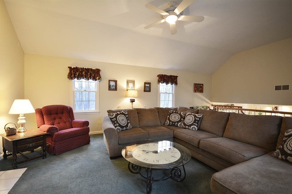 5 Ridge Road Pepperell, MA 01463 - Photo 7 of 25 a living room with furniture and a chandelier