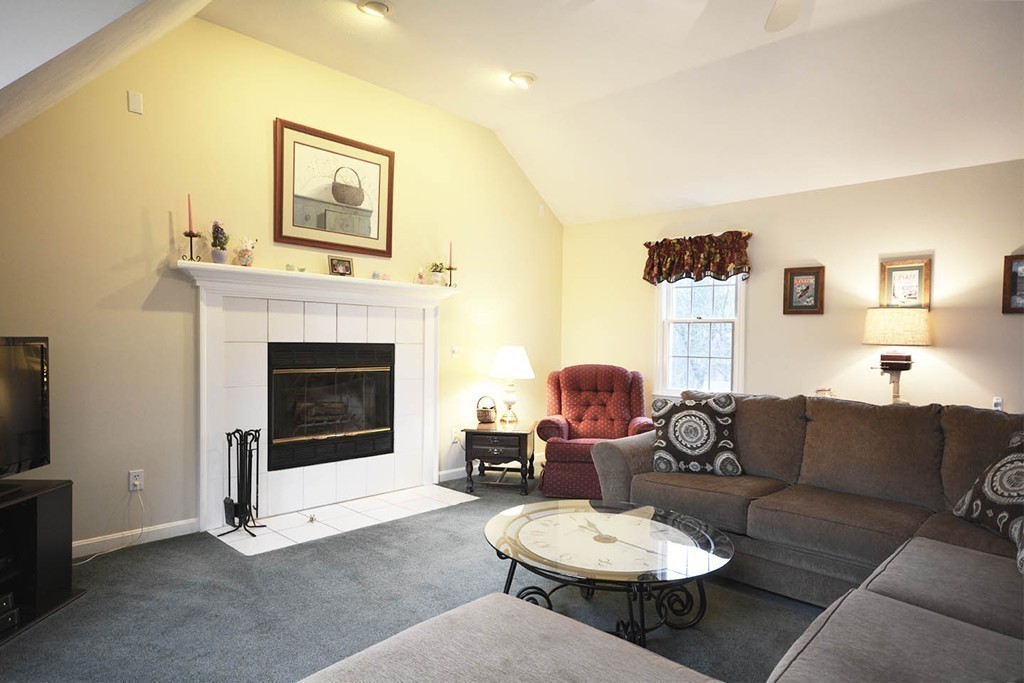 5 Ridge Road Pepperell, MA 01463 - Photo 8 of 25 a living room with furniture a fireplace and a flat screen tv