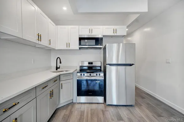 a kitchen with stainless steel appliances a refrigerator sink and cabinets