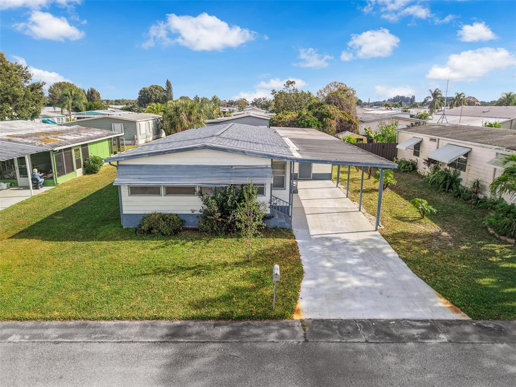 562 Ruth Circle Melbourne, FL 32904 - Photo 18 of 21 a view of a house with a yard and potted plants