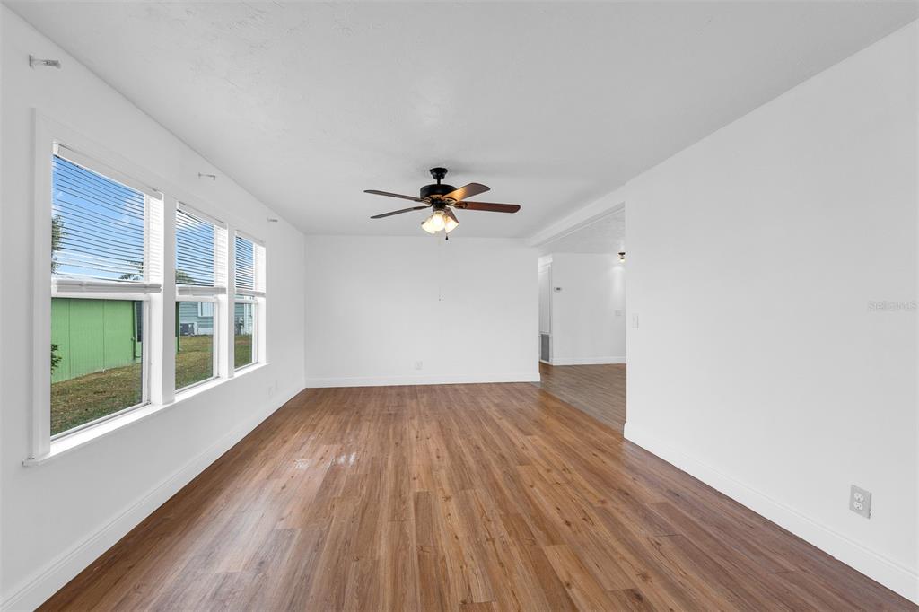 562 Ruth Circle Melbourne, FL 32904 - Photo 5 of 21 a view of empty room with wooden floor and fan