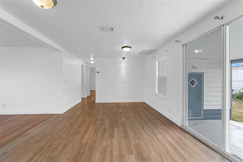 562 Ruth Circle Melbourne, FL 32904 - Photo 7 of 21 a view of a big room with wooden floor and windows