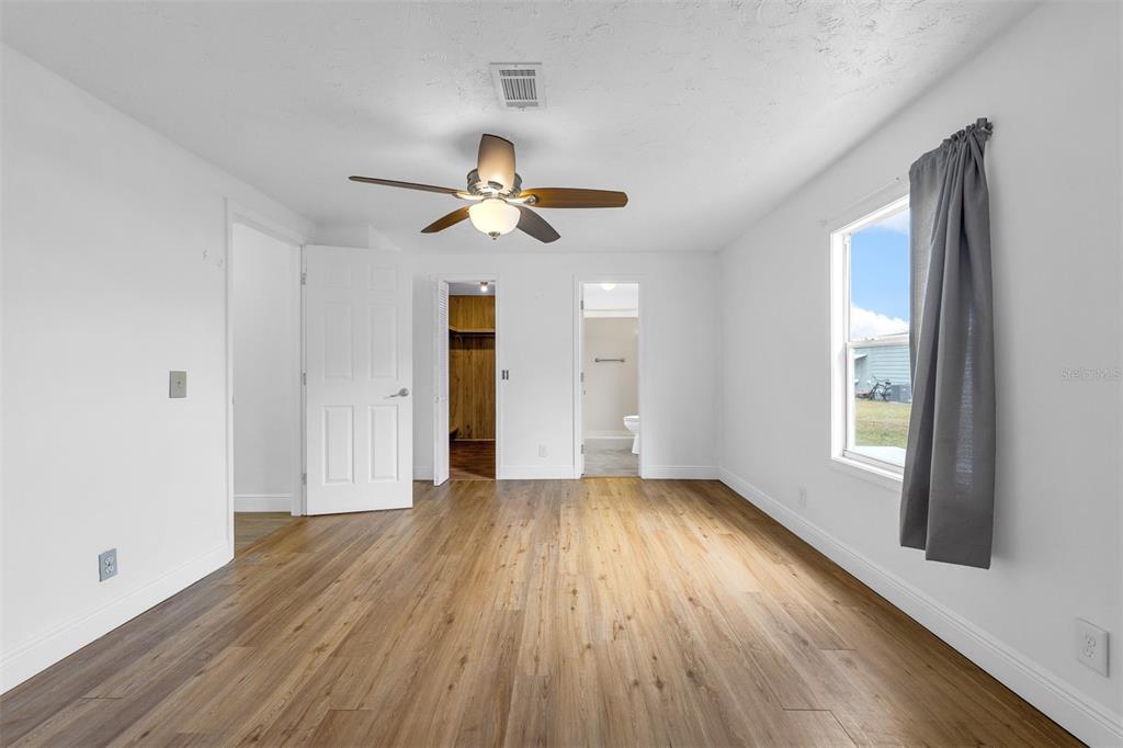 562 Ruth Circle Melbourne, FL 32904 - Photo 10 of 21 a view of an empty room with a window and wooden floor