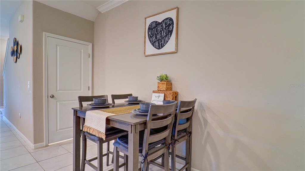 31632 Blue Passing Loop Wesley Chapel, FL 33545 - Photo 7 of 48 a view of a dining room with table and chairs