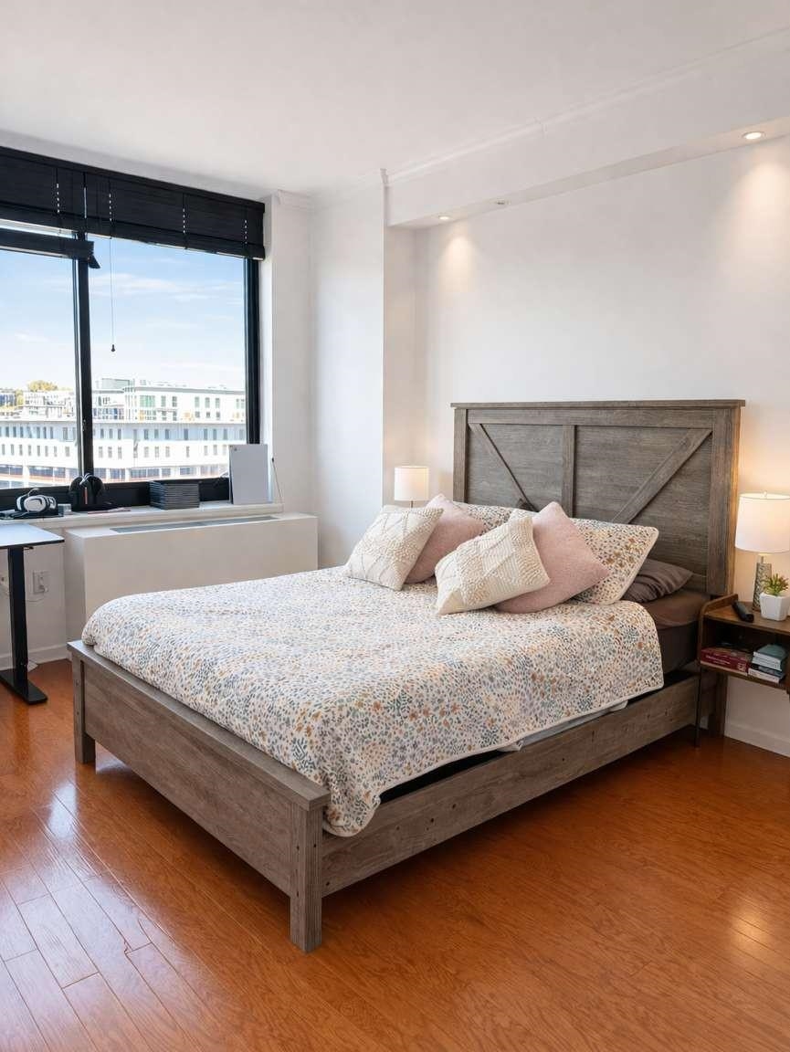 700 Grove Street, Unit 12F Jersey City, NJ 07310 - Photo 6 of 27 a bedroom with a bed and window
