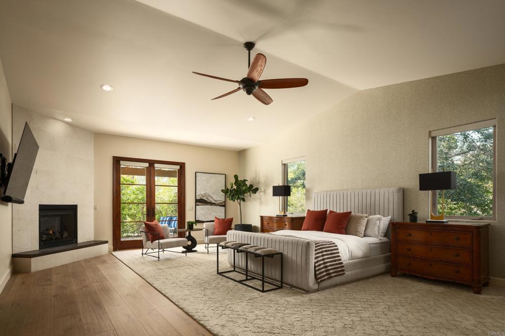 15731 Via De Santa Fe Rancho Santa Fe, CA 92067 - Photo 12 of 39 a bedroom with a bed and glass windows