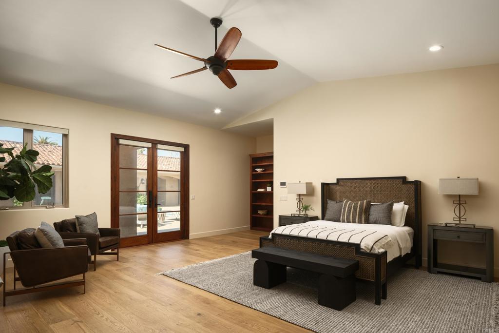 15731 Via De Santa Fe Rancho Santa Fe, CA 92067 - Photo 16 of 39 a spacious bedroom with a bed a couch and a large window