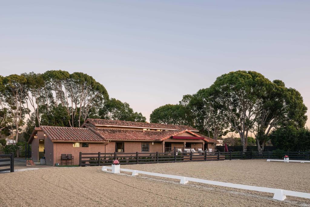 15731 Via De Santa Fe Rancho Santa Fe, CA 92067 - Photo 4 of 39 a patio with a table and chairs under an umbrella