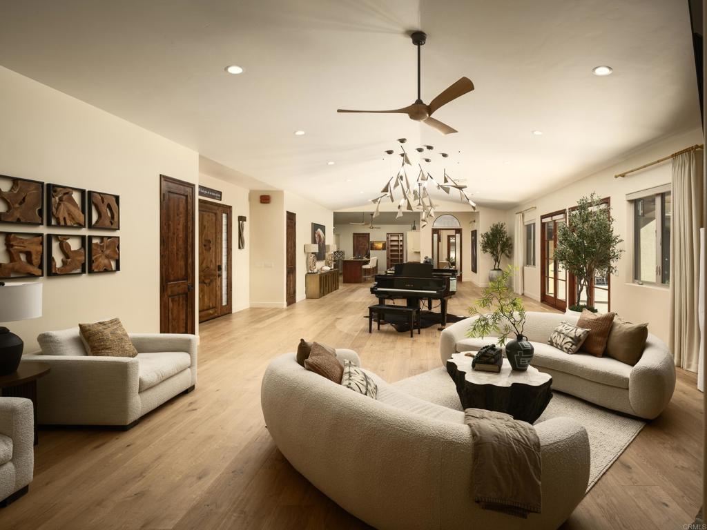 15731 Via De Santa Fe Rancho Santa Fe, CA 92067 - Photo 7 of 39 a living room with furniture and a chandelier