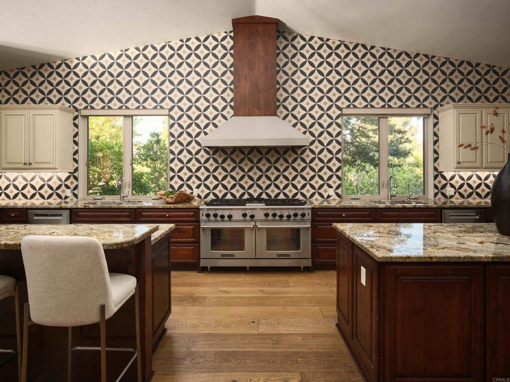 15731 Via De Santa Fe Rancho Santa Fe, CA 92067 - Photo 9 of 39 a kitchen with a wooden cabinets and a stove