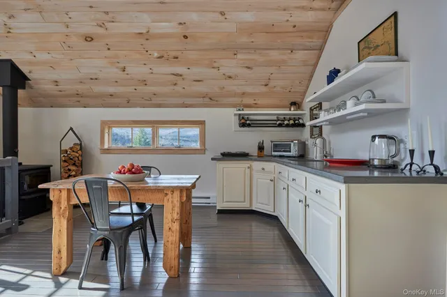 a kitchen with stainless steel appliances granite countertop a kitchen island a stove a table and chairs