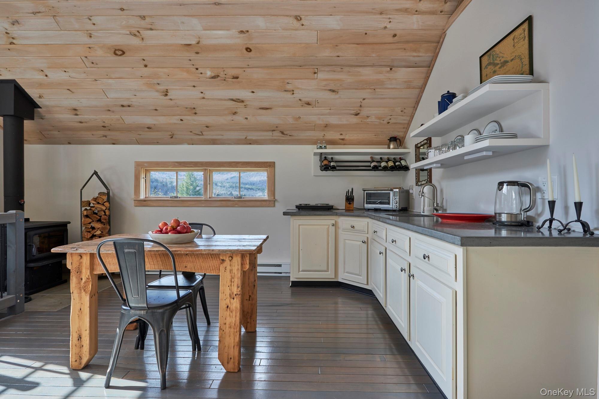 1681 Platte Clove Road Hunter, NY 12427 - Photo 11 of 23 a kitchen with stainless steel appliances granite countertop a kitchen island a stove a table and chairs
