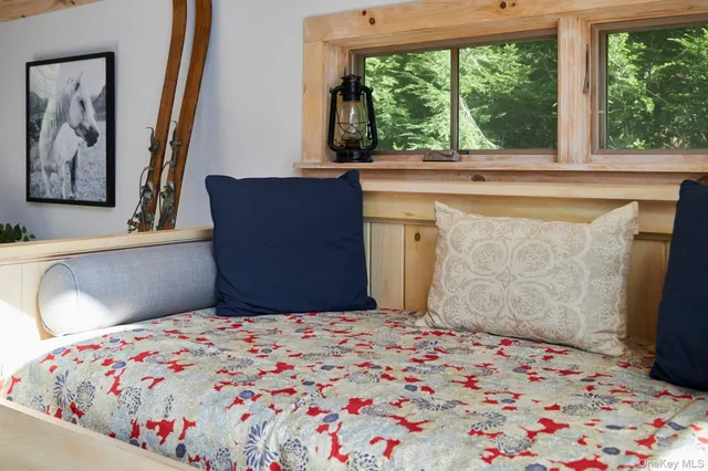 a bedroom with a bed and a window