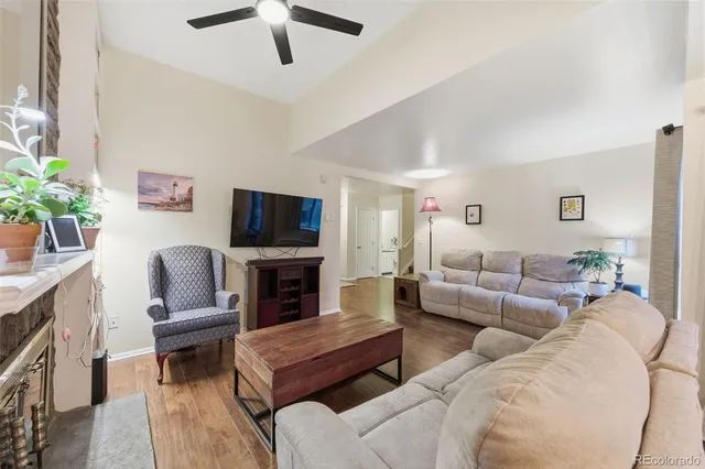 a living room with furniture a fireplace and a flat screen tv