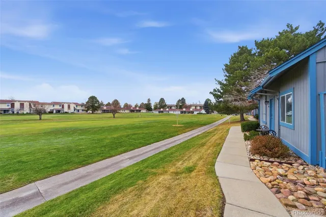 a view of swimming pool with a yard and green space