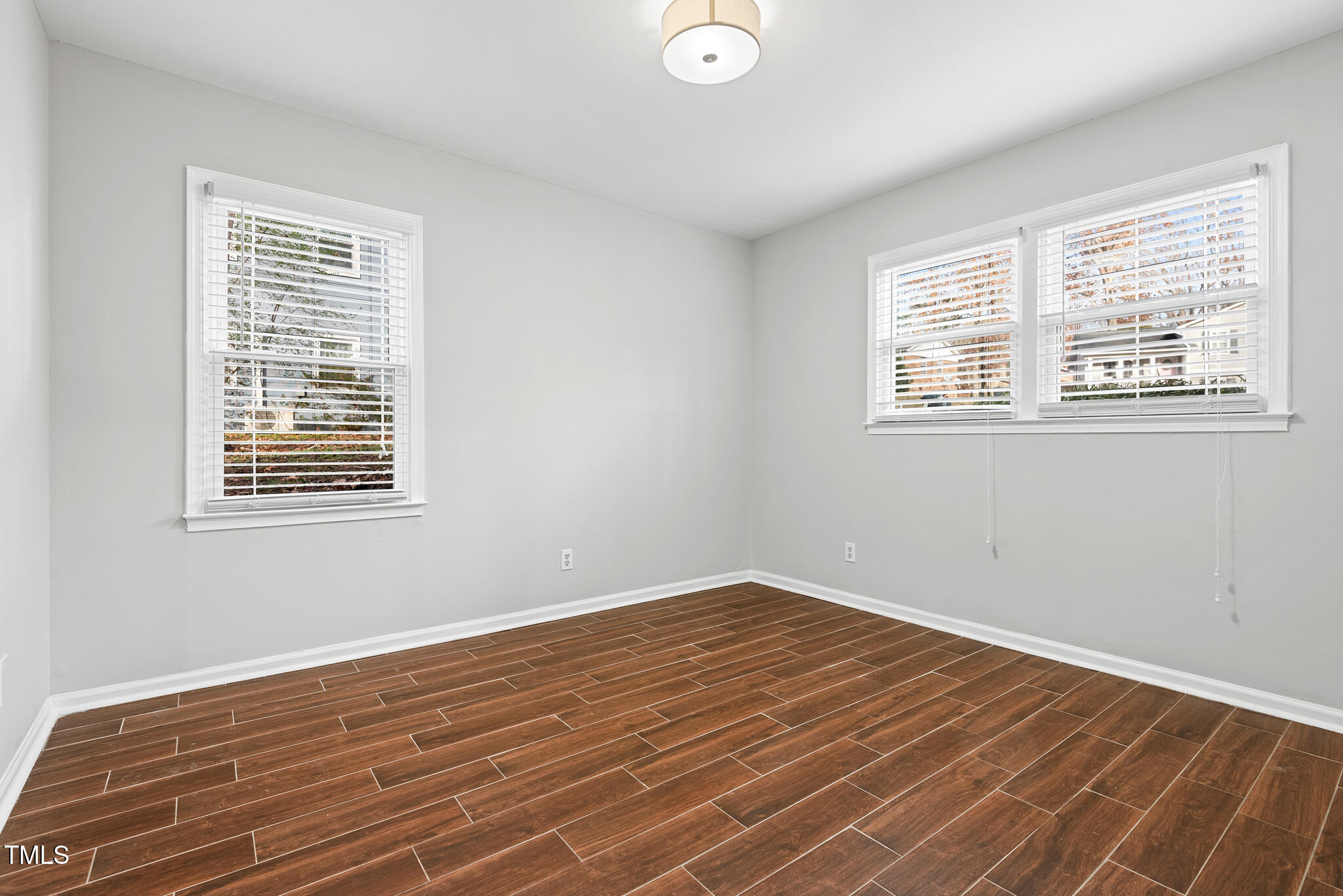 7309 Barberry Court Raleigh, NC 27615 - Photo 20 of 43 a view of a room with wooden floor and windows