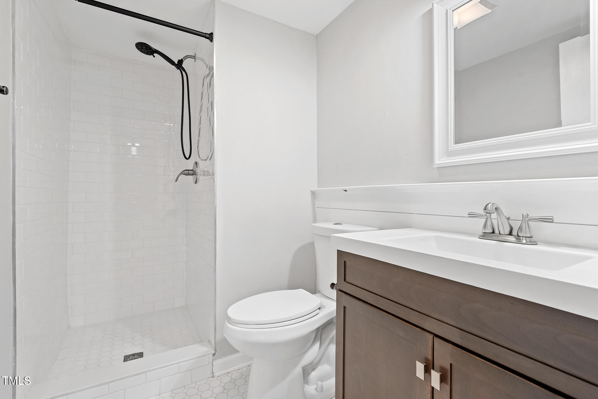 7309 Barberry Court Raleigh, NC 27615 - Photo 23 of 43 a bathroom with a sink a toilet and shower