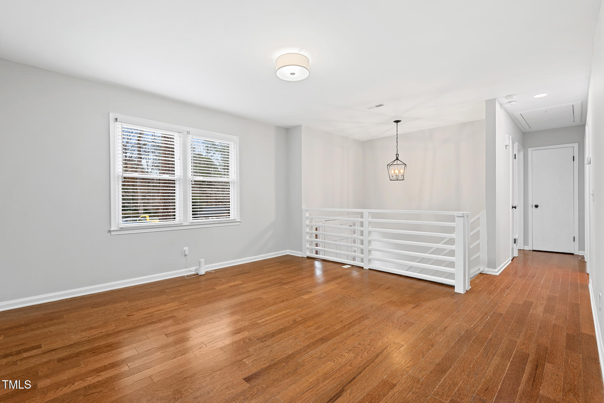 7309 Barberry Court Raleigh, NC 27615 - Photo 4 of 43 an empty room with wooden floor and windows