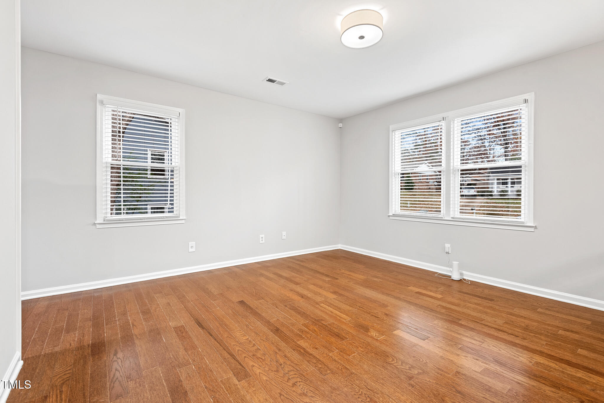 7309 Barberry Court Raleigh, NC 27615 - Photo 5 of 43 a view of an empty room with wooden floor and a window