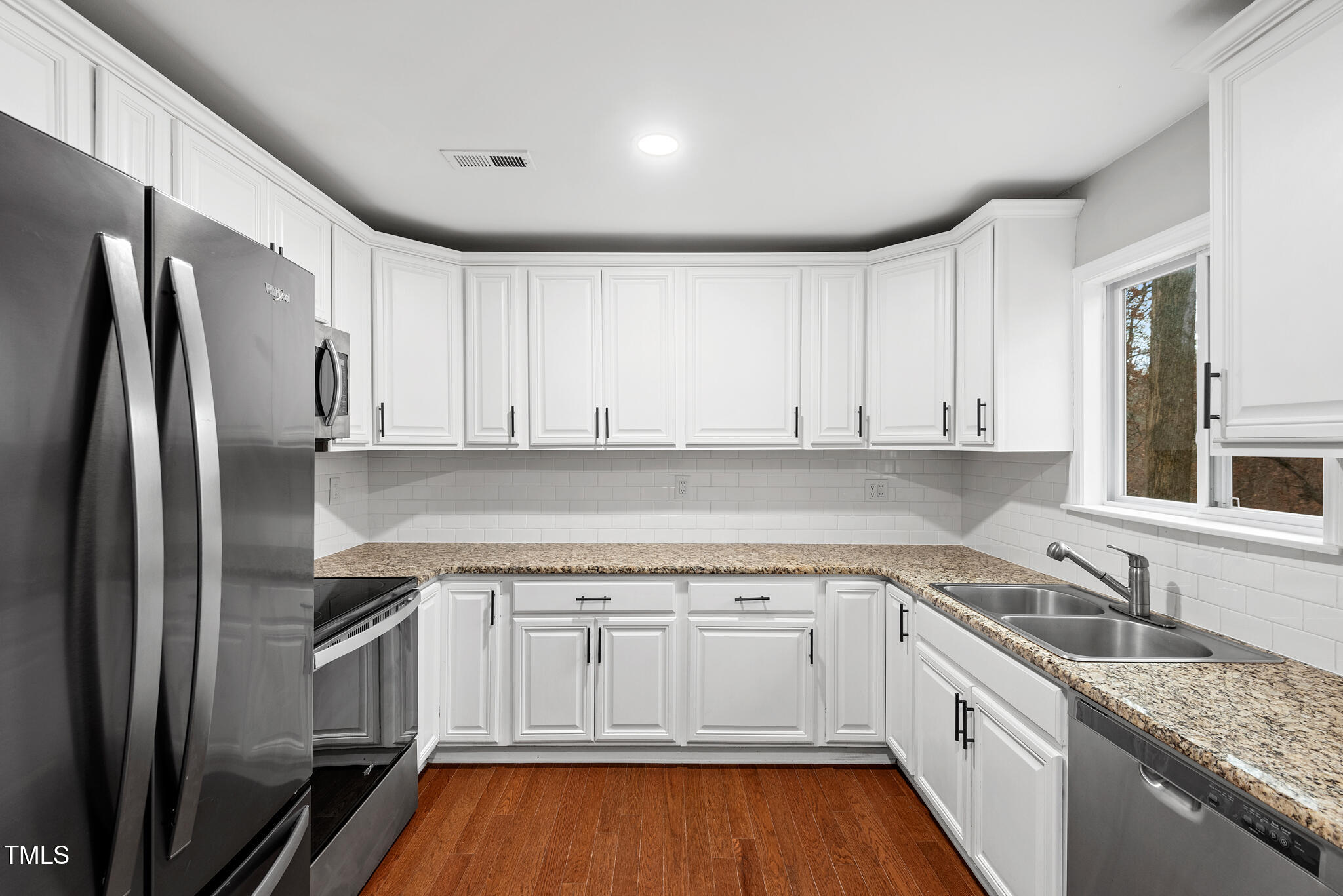 7309 Barberry Court Raleigh, NC 27615 - Photo 8 of 43 a kitchen with a sink stove and refrigerator