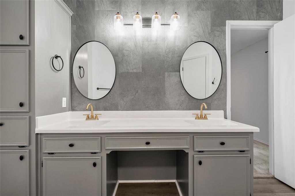 310 Ruth Drive Hewitt, TX 76643 - Photo 14 of 25 Dual oval mirrors above a spacious vanity with two undermount sinks in primary bathroom and gold-finish faucets