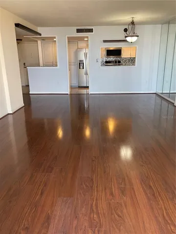a view of a living room with wooden floor