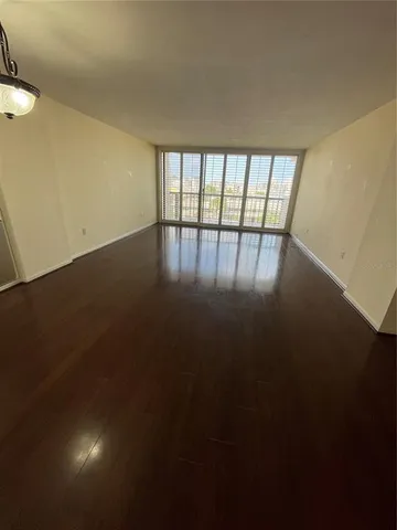 a view of wooden floor and windows in a room