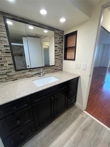 a bathroom with a double vanity sink and a mirror