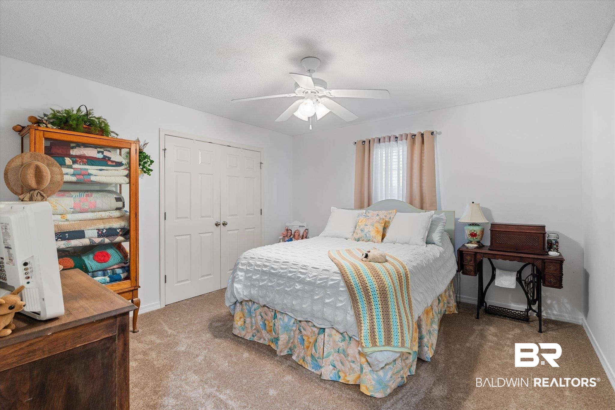 356 Collinwood Loop Foley, AL 36535 - Photo 8 of 21 Carpeted bedroom featuring ceiling fan, a closet, and a textured ceiling