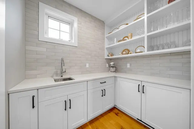 a kitchen with white cabinets and a sink