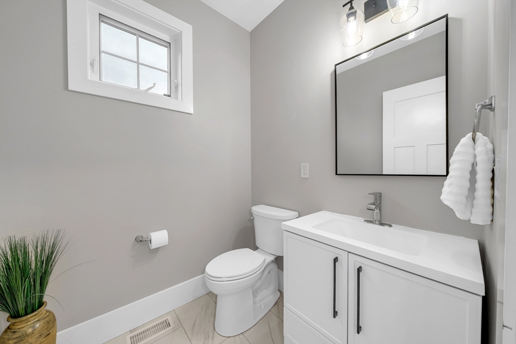 122 Seven Sister Road Haverhill, MA 01830 - Photo 15 of 33 a bathroom with a toilet sink and mirror