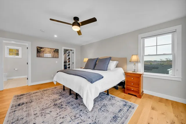 a bedroom with a bed and wooden floor