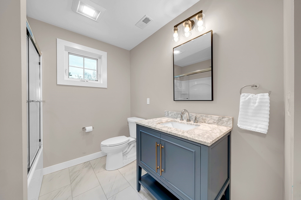 122 Seven Sister Road Haverhill, MA 01830 - Photo 22 of 33 a bathroom with a toilet sink and mirror