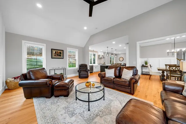 a living room with furniture a large window and a rug