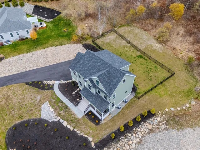 an aerial view of a house with a yard