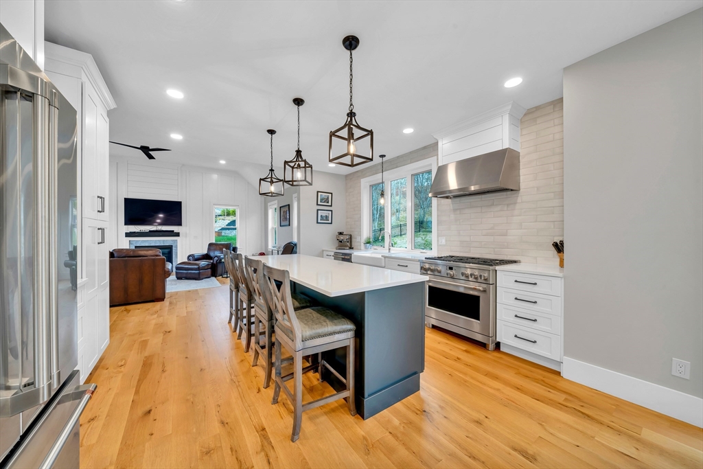 122 Seven Sister Road Haverhill, MA 01830 - Photo 9 of 33 a kitchen with stainless steel appliances a dining table chairs stove and sink
