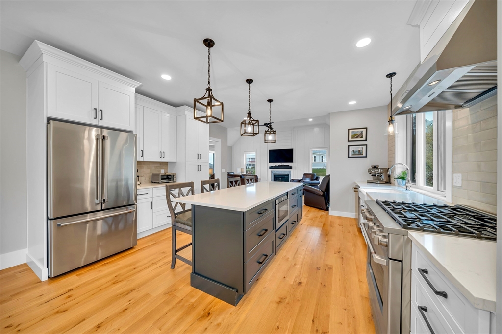 122 Seven Sister Road Haverhill, MA 01830 - Photo 10 of 33 a large kitchen with stainless steel appliances granite countertop a lot of cabinets and wooden floor