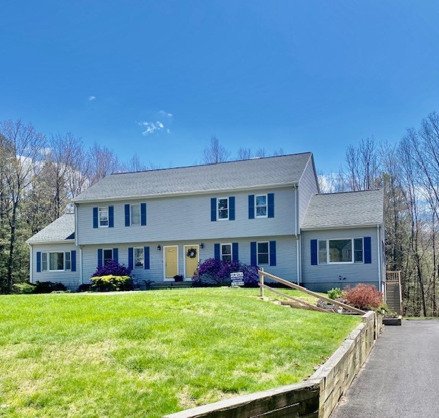 141 East County Road, Unit 141 Rutland, MA 01543 - Photo 1 of 27 a front view of a house with a yard table and chairs