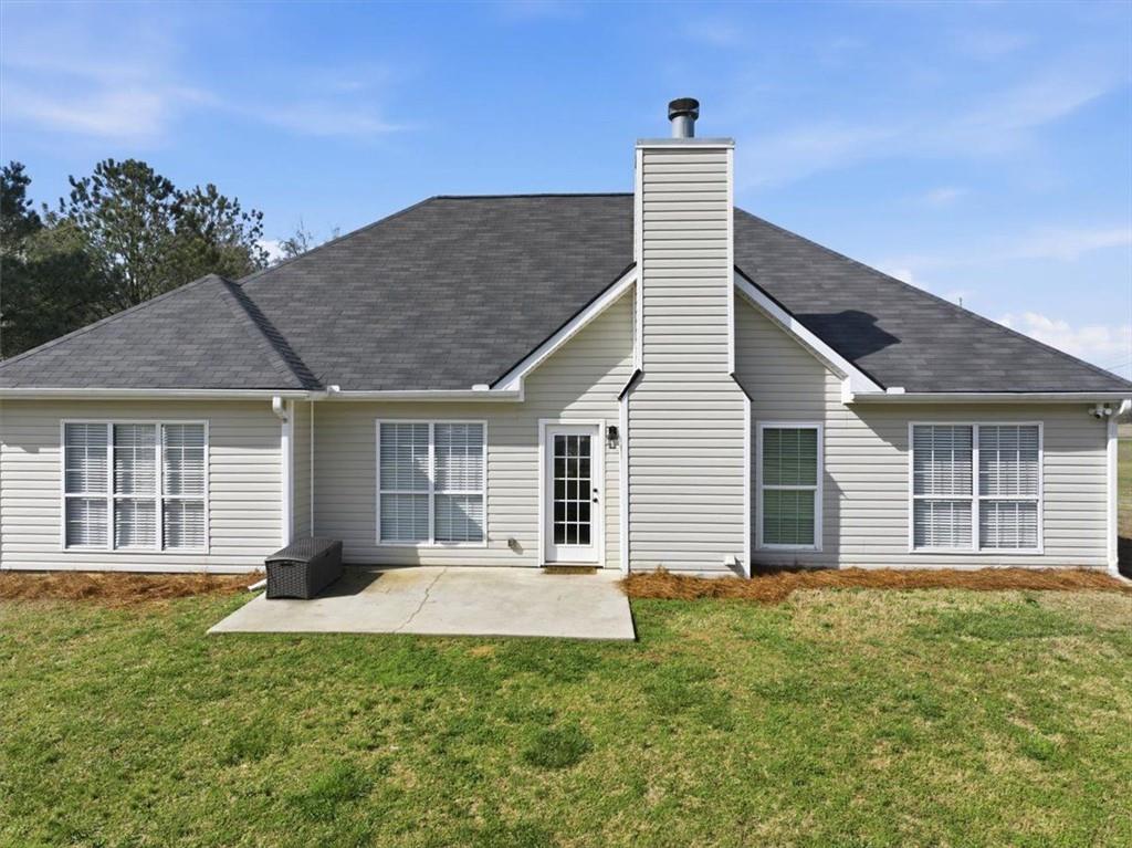 493 Youth Jersey Road Covington, GA 30014 - Photo 36 of 52 a front view of a house with a garden