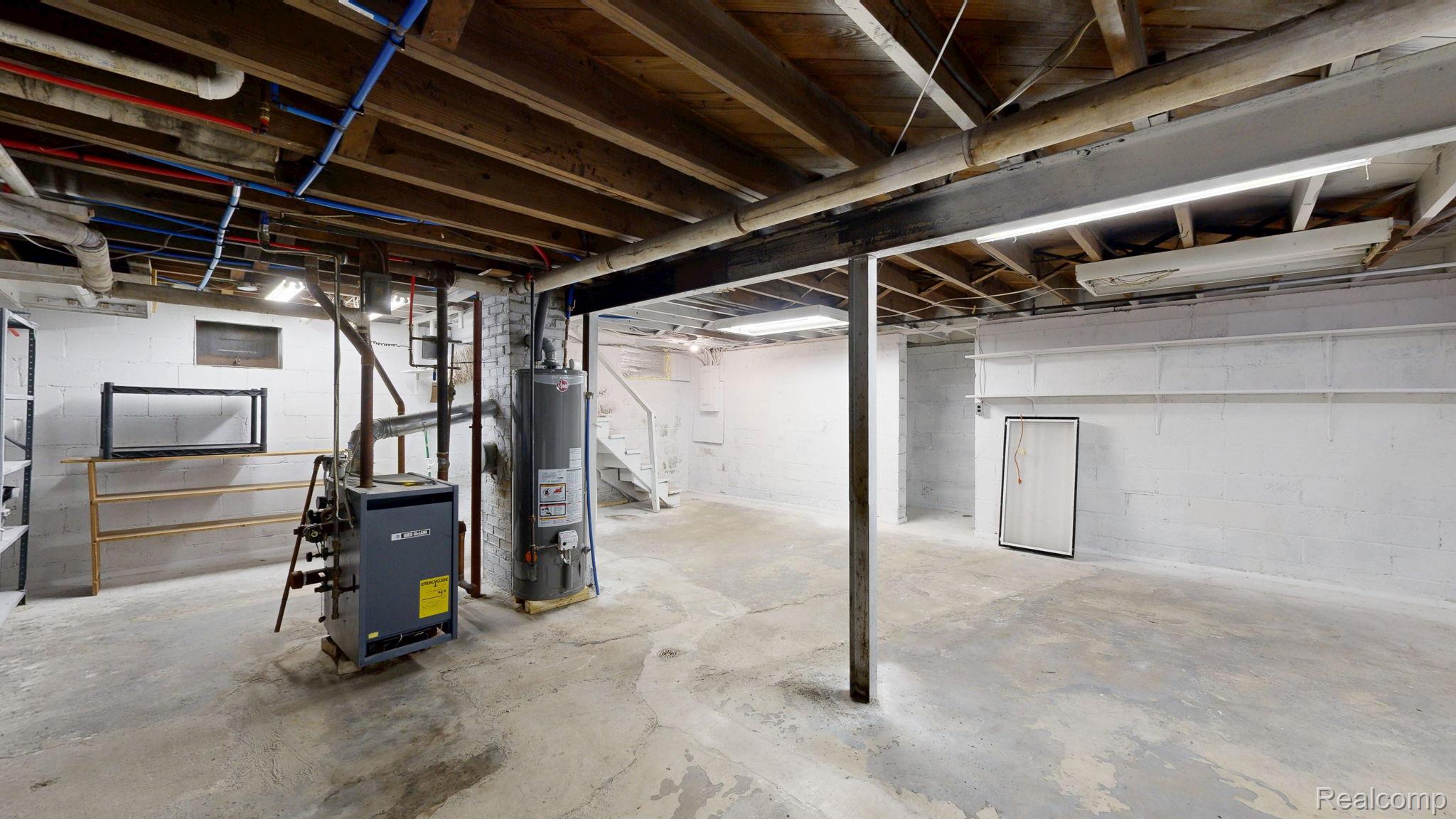 4455 North Genesee Road Flint, MI 48506 - Photo 25 of 47 Unfinished basement featuring stairway, gas water heater, and a heating unit