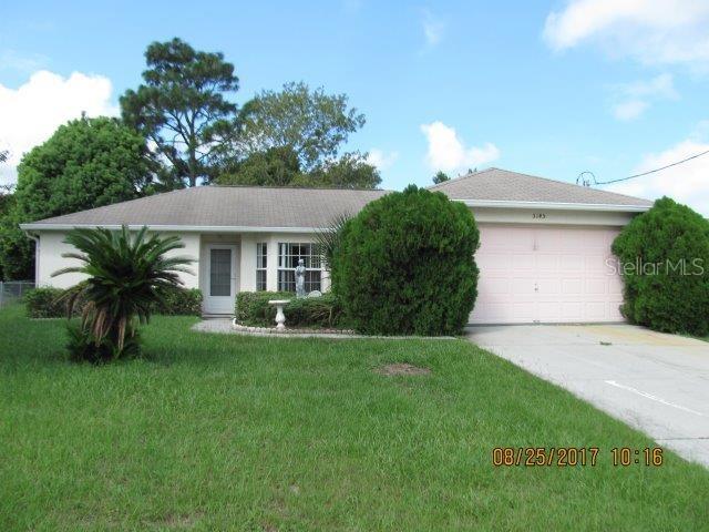 5145 Boswell Road Spring Hill, FL 34608 - Photo 1 of 1 a front view of a house with a yard and garage